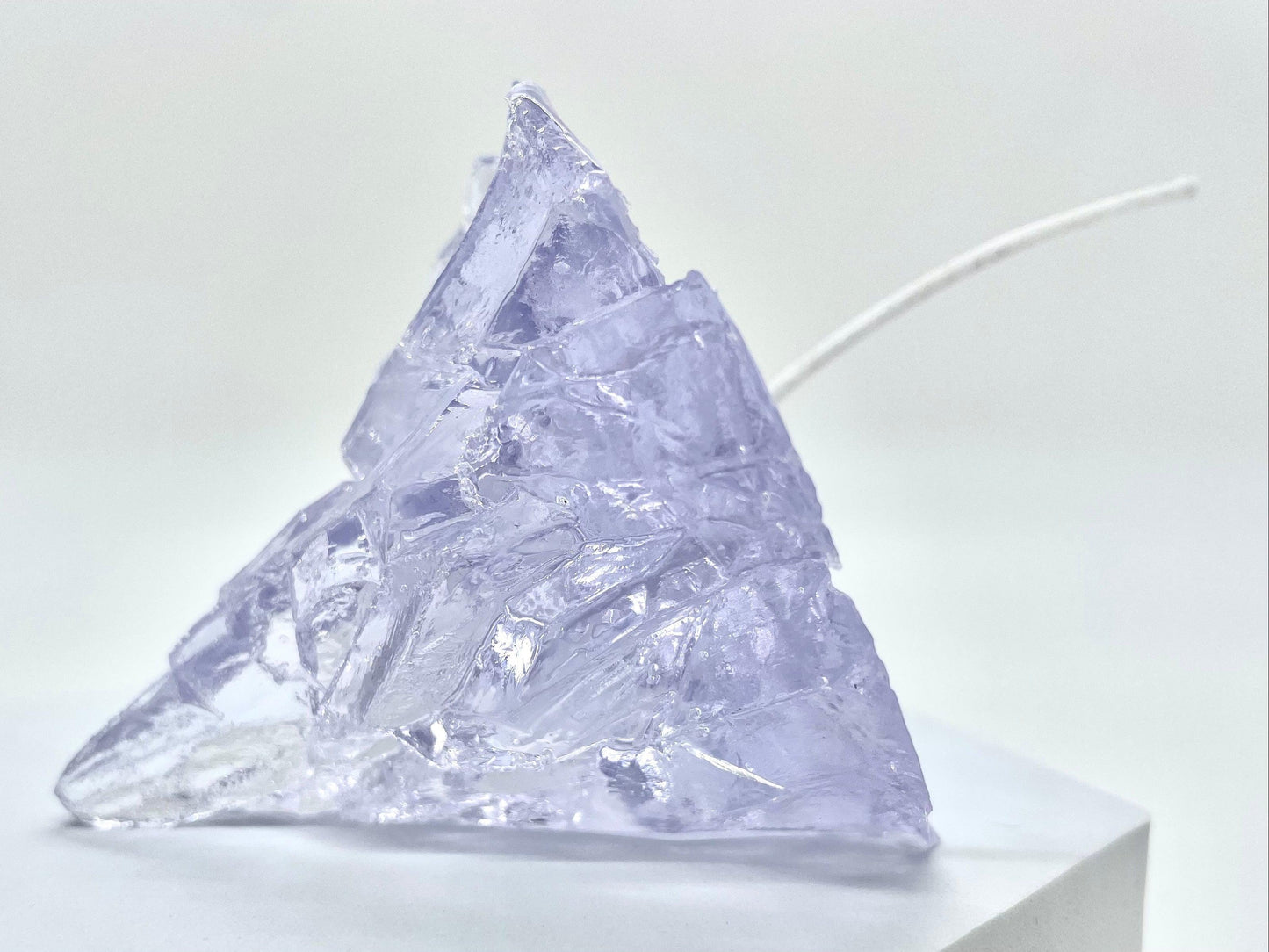 Elegant, romantic, handmade transparent 3D floating iceberg made of jelly wax, clear wick.